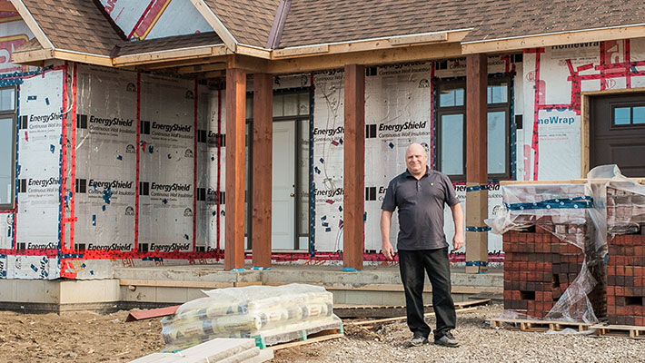 man standing outside of home