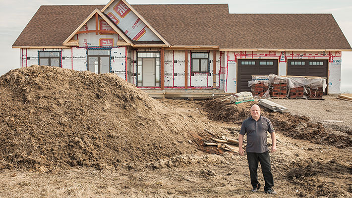 man standing outside of home