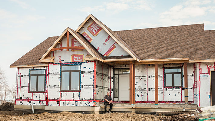 man standing outside of home