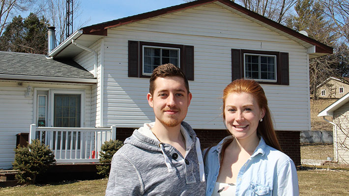 couple in front of their home